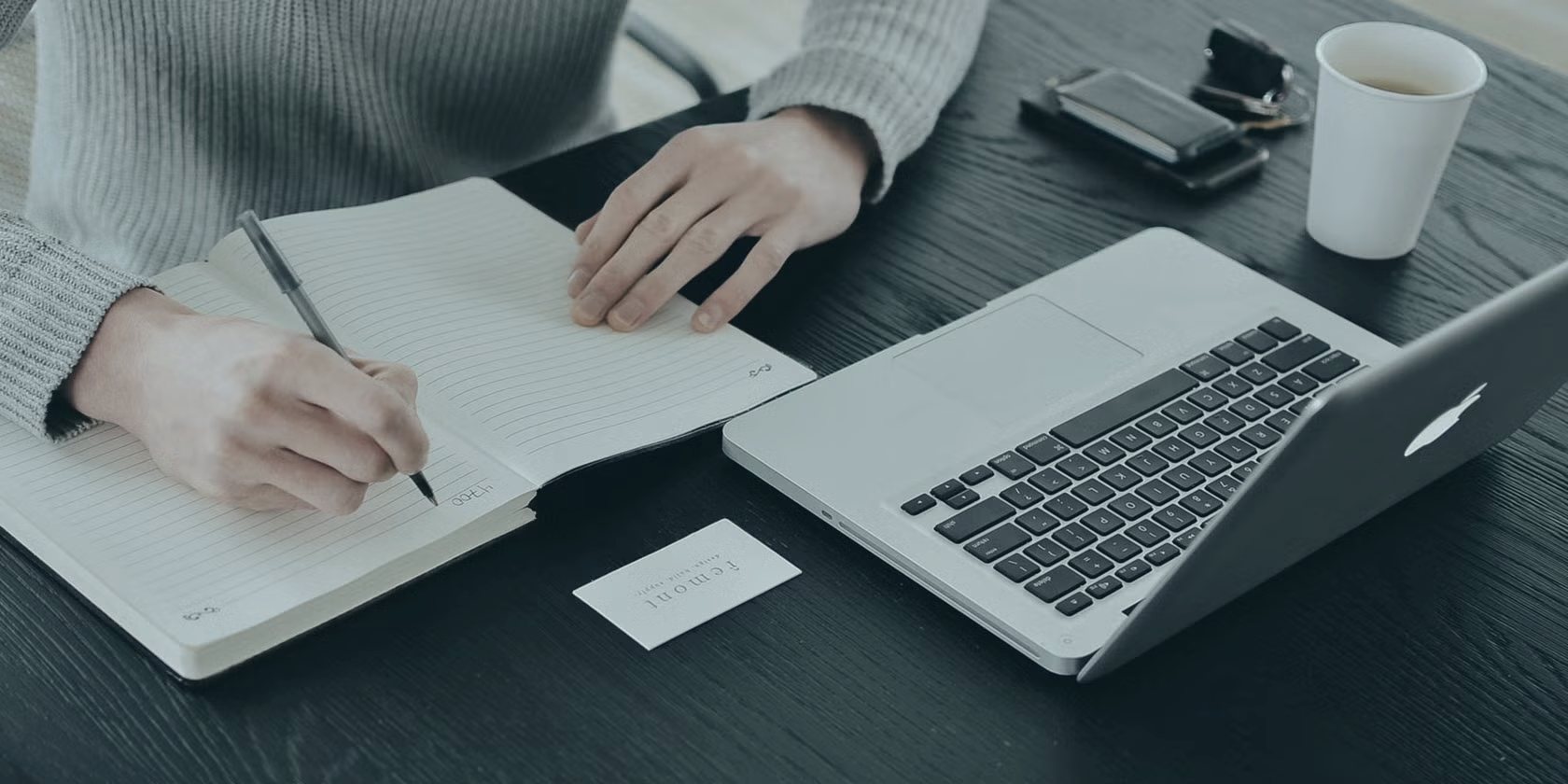 Notebook and laptop on a desk